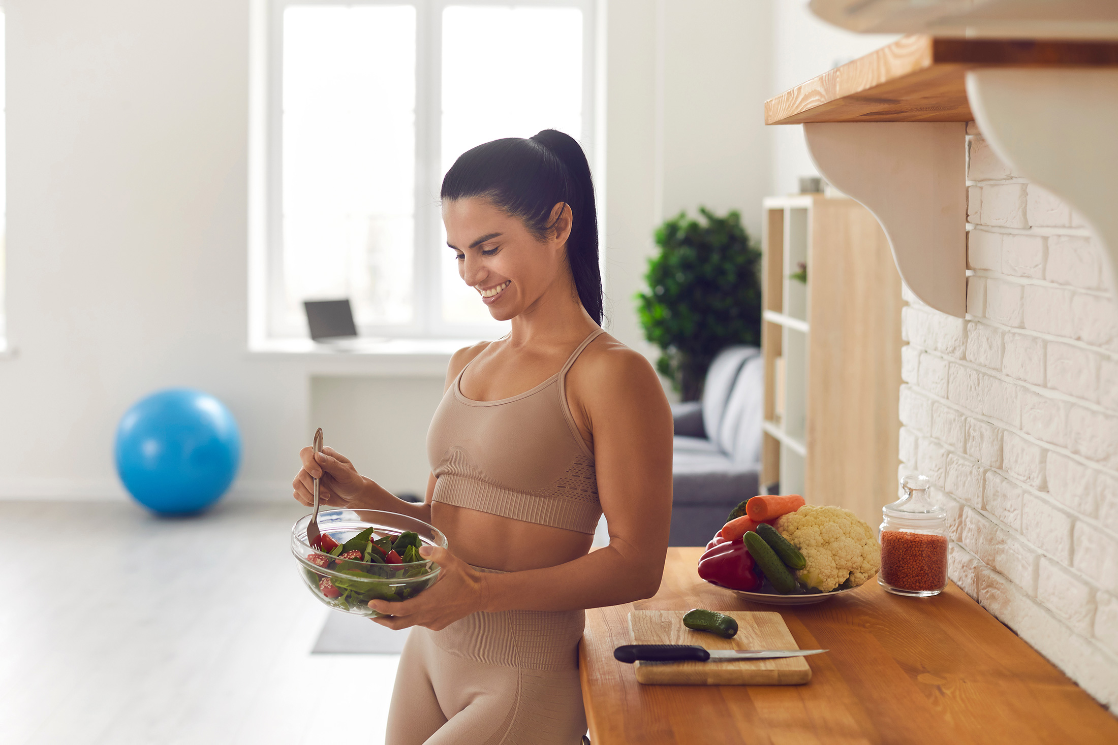 smiling woman eating salad