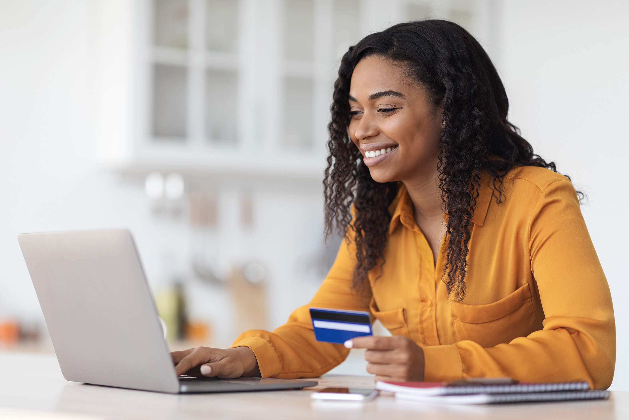 smiling woman holding credit card